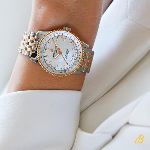 The white dial fake watch has diamond hour marks.